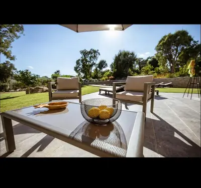 a table with a bowl of fruit on a patio at Villa l'orangerie, 2 chambres , Piscine, 4personnes in Lecci