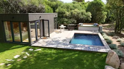 a tiny house with a pool in a yard at Chalet Alivi in Porto-Vecchio
