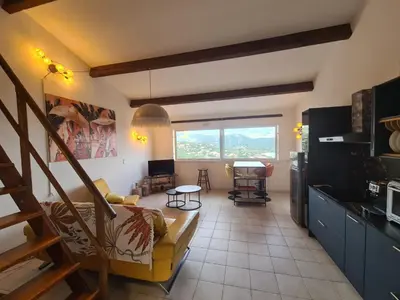 a living room with a couch and a table at Appartement 