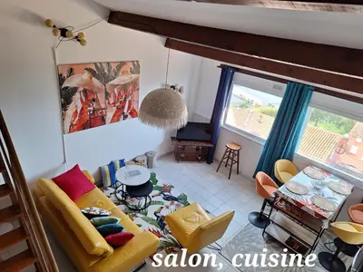 a living room with a couch and a table at Appartement 
