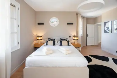 a bedroom with a large white bed with two pillows at Château di Cardiccia a Luxury 7-Bedroom Villa with Air Conditioning in Zonza