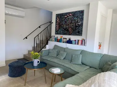 a bedroom with a bed and a wooden cabinet at Villa Ô Bord de Mer avec piscine privée in Conca