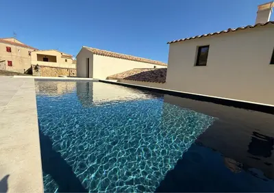 a swimming pool in front of a house at Villa familiale avec piscine,15 min des plages in Lavatoggio