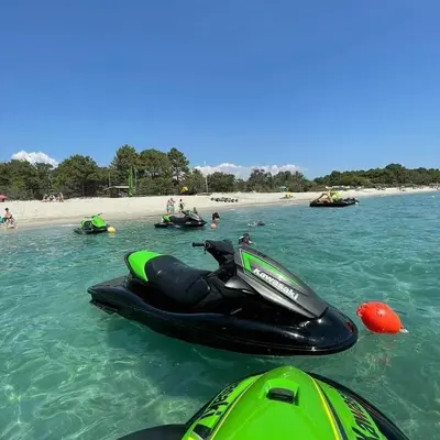 a jet ski in the water next to a beach at E case di u Puntale in Ghisonaccia
