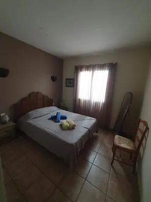 a bedroom with a bed with two towels on it at E case di u Puntale in Ghisonaccia