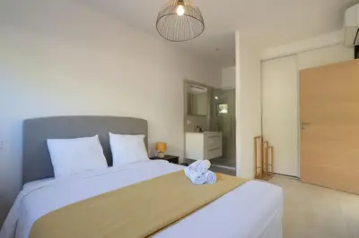 a bedroom with a large white bed and a mirror at Villa Oia - avec piscine privée in Conca