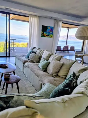 a living room with a couch and a table at Large Family Villa, exceptional sea view in Coti-Chiavari