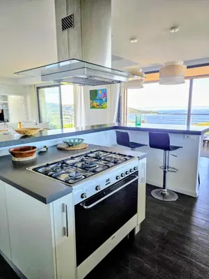 a kitchen with a stove and a counter top at Large Family Villa, exceptional sea view in Coti-Chiavari