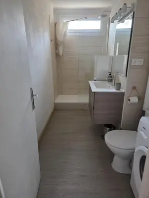 a white bathroom with a toilet and a sink at Quiet flat in Ajaccio neat beaches and downtown in Ajaccio