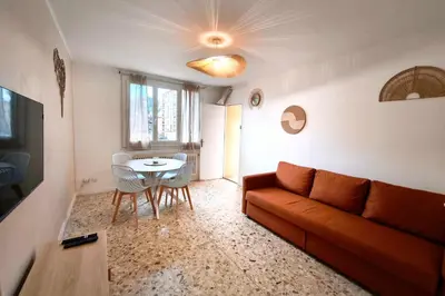 a dining room with a table and chairs and a television at Quiet flat in Ajaccio neat beaches and downtown in Ajaccio