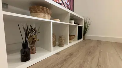 a room with white shelves with vases and plants at Appartement T2 jardin & accès plage privée in Grosseto-Prugna