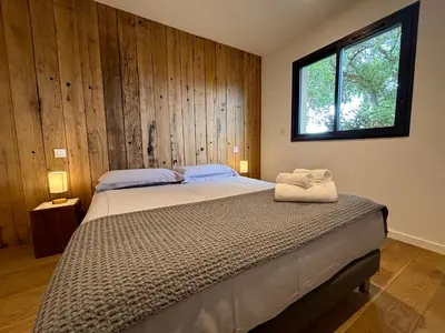 a bedroom with a large bed with a window at Bergerie Sébastien in Zonza