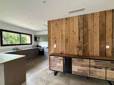 a kitchen with wood paneled walls and a counter at Bergerie Sébastien in Zonza