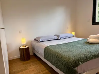 a bedroom with a bed and a lamp on a table at Bergerie Sébastien in Zonza
