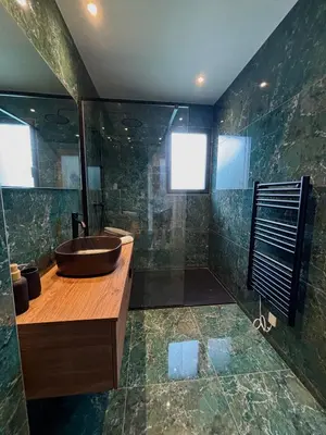 a bathroom with a wooden sink and a shower at Bergerie Sébastien in Zonza