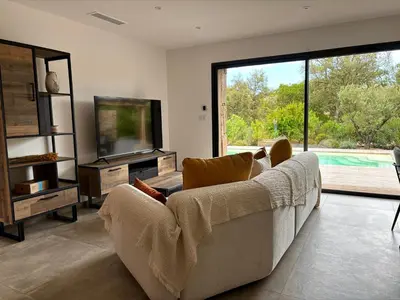 a living room with a couch and a television at Bergerie Sébastien in Zonza
