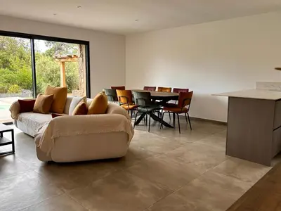 a living room with a couch and a table at Bergerie Sébastien in Zonza