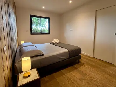 a bedroom with a bed with a table and a window at Bergerie Sébastien in Zonza