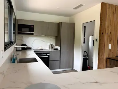 a kitchen with marble counter tops and a sink at Bergerie Sébastien in Zonza