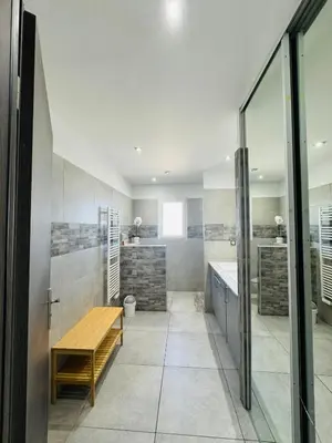 a bathroom with a wooden table and a bench at Villa Pietralba - Piscine privée & vue montagne - Proche Calvi in Calenzana