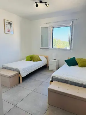 a bedroom with two beds and a window at Villa Pietralba - Piscine privée & vue montagne - Proche Calvi in Calenzana