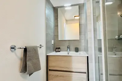 a bathroom with a sink and a shower at Mini-villa dans résidence avec piscine T2 BONIFACIO in Bonifacio