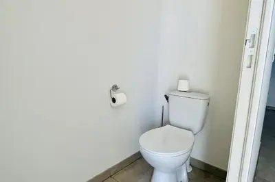a bathroom with a toilet and a roll of toilet paper at Mini-villa dans résidence avec piscine T2 BONIFACIO in Bonifacio