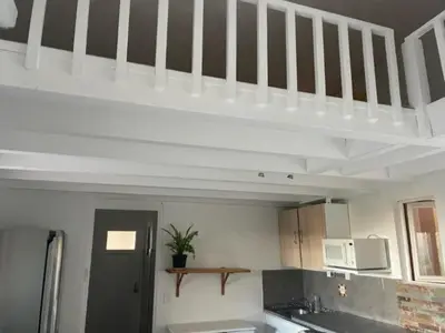 a kitchen with a loft bed in a room at Famille in Grosseto-Prugna