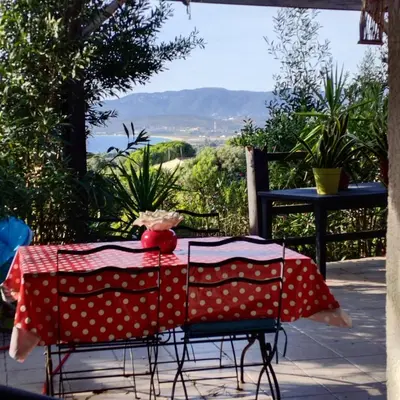 a table with a red and white polka dot table cloth at Famille in Grosseto-Prugna