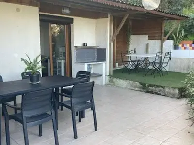 a black table and chairs sitting on a patio at Famille in Grosseto-Prugna