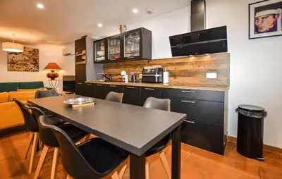 a kitchen with a table and chairs and a counter at Awesome Home In Vero With Private Swimming Pool, Can Be Inside Or Outside in Vero