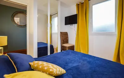 a bedroom with a blue bed and a window at Awesome Home In Vero With Private Swimming Pool, Can Be Inside Or Outside in Vero