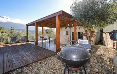 a large grill on a patio with a wooden deck at Awesome Home In Vero With Private Swimming Pool, Can Be Inside Or Outside in Vero