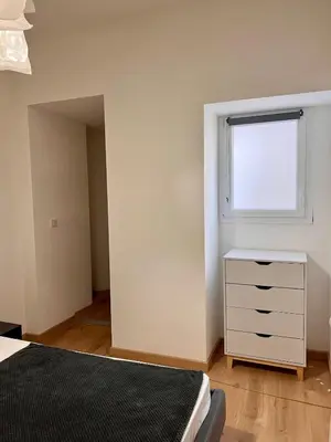 a bedroom with a white dresser and a window at Village centre appartement in Calenzana