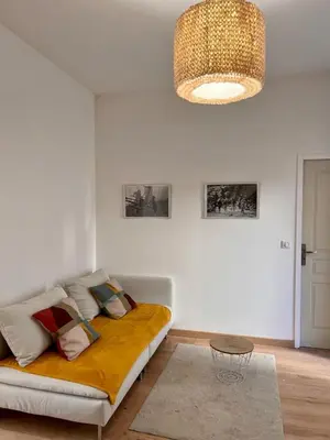 a bedroom with a bed and a chandelier at Village centre appartement in Calenzana