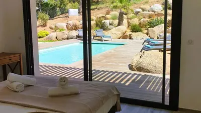 a bedroom with a view of a swimming pool at Villa Maria 1. 12 pers, piscine chauffée, 5 min plage in Cirendinu