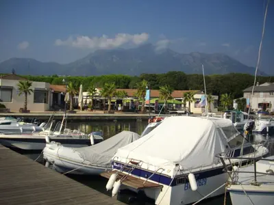 a group of boats docked at a dock with mountains at Holiday Home Sole e Ventu by Interhome in Velone-Orneto