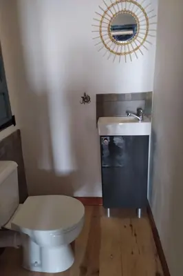 a bathroom with a toilet and a mirror on the wall at Holiday Home Sole e Ventu by Interhome in Velone-Orneto