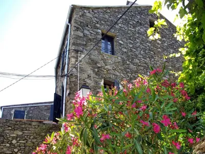 a stone building with pink flowers in front of it at Apartment Sole e Ventu 70qm by Interhome in San-Giovanni-di-Moriani