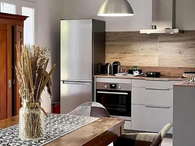 a kitchen with a table and a refrigerator at Apartment Résidence Amanda by Interhome in Santa-Lucia-di-Moriani