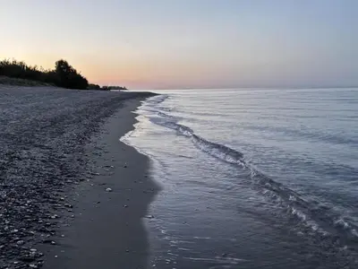 a beach with the ocean and the shoreline at Apartment Résidence Amanda by Interhome in Santa-Lucia-di-Moriani