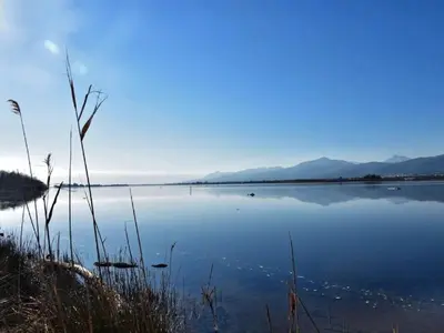 a large body of water with mountains in the background at Apartment Résidence Amanda by Interhome in Santa-Lucia-di-Moriani