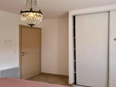 a chandelier hanging over a room with a closet at Apartment Résidence Amanda by Interhome in Santa-Lucia-di-Moriani