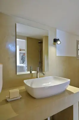 a bathroom with a large white sink and a mirror at Holiday Home Domaine Punta della Guardia Maison A Figa mit Blick auf das Meer by Interhome in Cervione