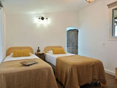 a bedroom with two beds and a window at Holiday Home Domaine Punta della Guardia Maison A Figa mit Blick auf das Meer by Interhome in Cervione
