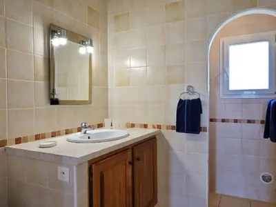 a bathroom with a sink and a mirror at Holiday Home Weingut Punta della Guardia Ruhig und beschaulich by Interhome in Cervione