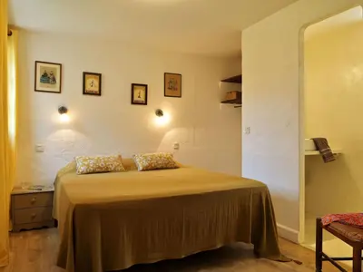a bedroom with a bed with two pillows on it at Holiday Home Weingut Punta della guardia zwischen Meer und Gebirge by Interhome in Cervione