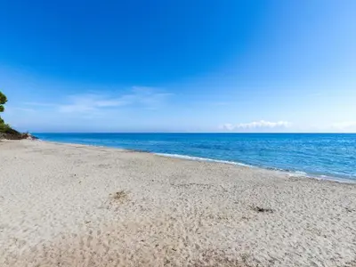 a sandy beach with the ocean in the background at Holiday Home Weingut Punta della guardia zwischen Meer und Gebirge by Interhome in Cervione