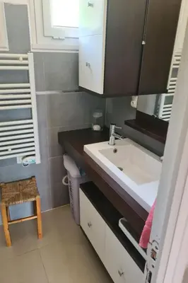 a bathroom with a sink and a mirror at Holiday Home Casa zinu mit Blick aufs Meer by Interhome in Cargèse