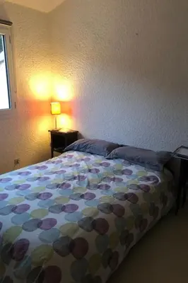 a bedroom with a bed with a flowered blanket at Holiday Home Casa zinu mit Blick aufs Meer by Interhome in Cargèse